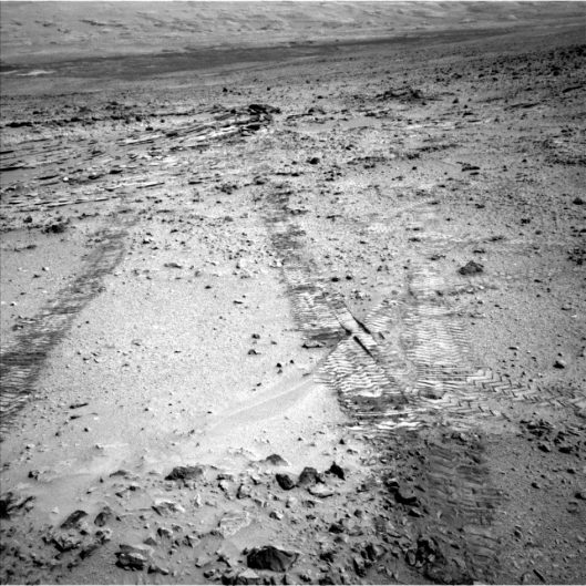 Curiosity snaps a picture of the marks made by its wheels as the one-ton rover heads toward Mount Sharp.  Credit: NASA/JPL-Caltech